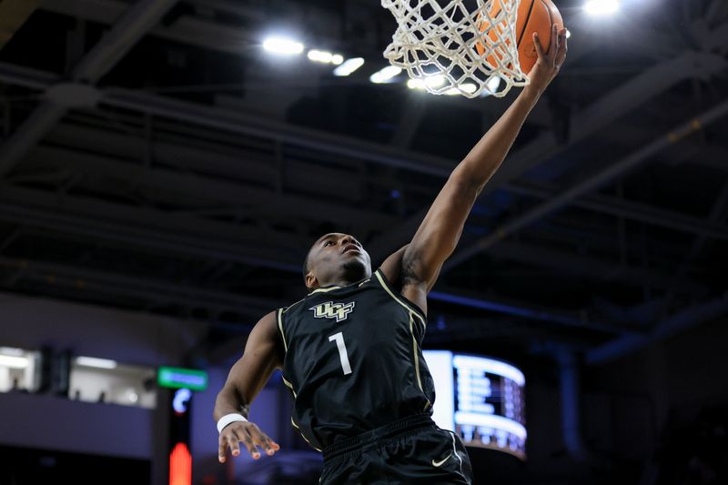 Feb 4, 2023; Cincinnati, Ohio, USA;  UCF Knights guard Jayhlon Young (1) drives to the basket against the Cincinnati Bearcats in the second half at Fifth Third Arena. Mandatory Credit: Aaron Doster-USA TODAY Sports