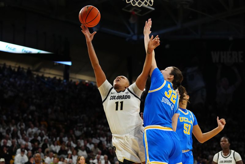 Jan 19, 2024; Boulder, Colorado, USA; Colorado Buffaloes forward Quay Miller (11) shoots over UCLA Bruins forward Angela Dugalic (32) in the second half at the CU Events Center. Mandatory Credit: Ron Chenoy-USA TODAY Sports
\v11