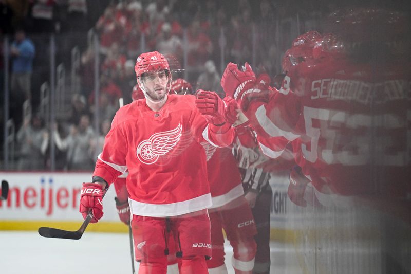 Feb 27, 2024; Detroit, Michigan, USA; Detroit Red Wings defenseman Shayne Gostisbehere (41) celebrates his goal with teammates during the first period against the Washington Capitals at Little Caesars Arena. Mandatory Credit: Tim Fuller-USA TODAY Sports