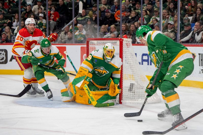 Jan 25, 2025; Saint Paul, Minnesota, USA; Minnesota Wild defenseman Brock Faber (7) plays the puck in front of goaltender Marc-Andre Fleury (29) against the Calgary Flames in the third period at Xcel Energy Center. Mandatory Credit: Matt Blewett-Imagn Images