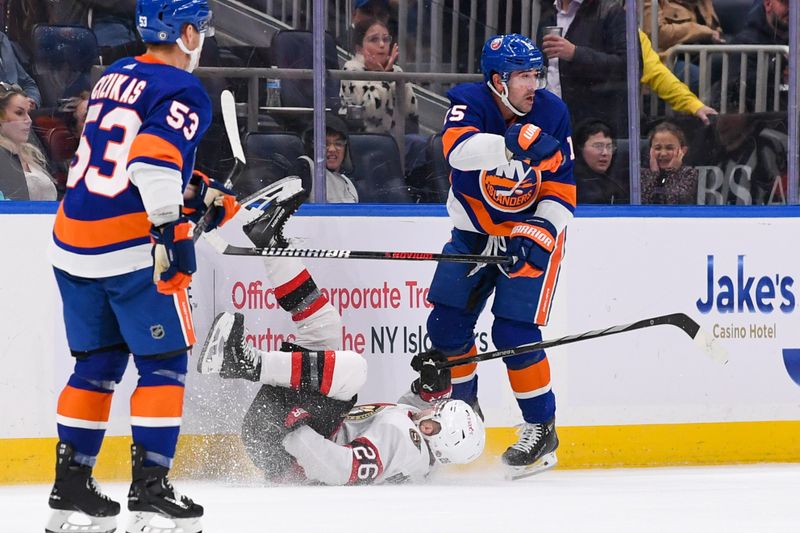 Oct 26, 2023; Elmont, New York, USA; New York Islanders right wing Cal Clutterbuck (15) checks Ottawa Senators defenseman Erik Brannstrom (26) into the boards during the second period at UBS Arena. Mandatory Credit: Dennis Schneidler-USA TODAY Sports