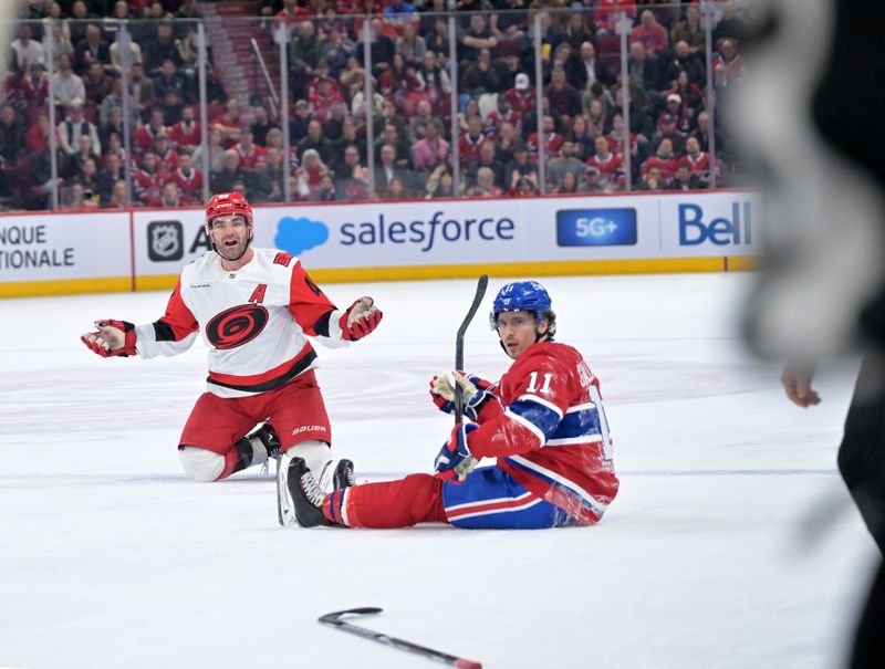 Mar 24, 2026; Montreal, Quebec, CAN; Carolina Hurricanes forward Jordan Martinook (48) and Montreal Canadiens forward Brendan Gallagher (11) look back at the official during the second period at the Bell Centre. Mandatory Credit: Eric Bolte-Imagn Images