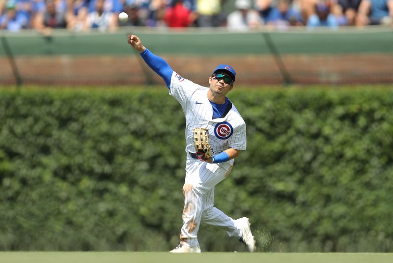 May 31, 2024; Chicago, Illinois, USA; Chicago Cubs outfielder Seiya Suzuki (27) throws the ball into play 
during the fourth inning against the Cincinnati Reds at Wrigley Field. Mandatory Credit: Melissa Tamez-USA TODAY Sports