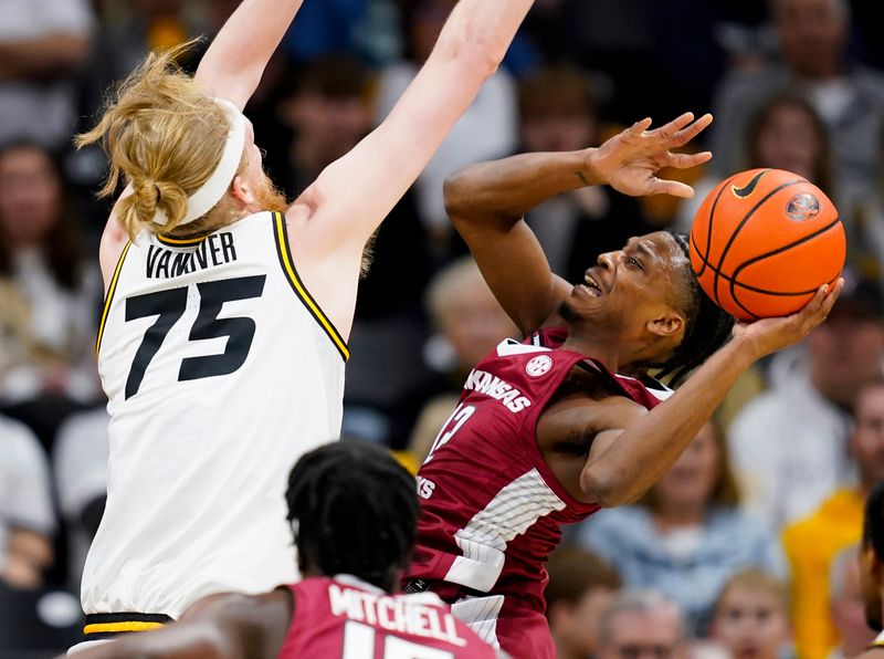 Jan 31, 2024; Columbia, Missouri, USA; Arkansas Razorbacks guard Tramon Mark (12) shoots against Missouri Tigers center Connor Vanover (75) during the first half at Mizzou Arena. Mandatory Credit: Jay Biggerstaff-USA TODAY Sports