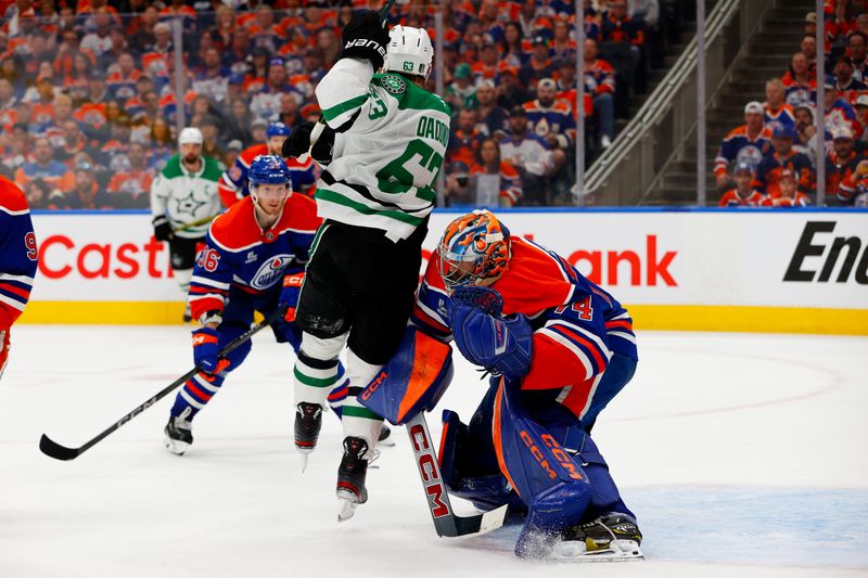 May 25, 2025; Edmonton, Alberta, CAN; Dallas Stars right wing Evgenii Dadonov (63) collides with Edmonton Oilers goaltender Stuart Skinner (74) during the second period in game three of the Western Conference Final of the 2025 Stanley Cup Playoffs at Rogers Place. Mandatory Credit: Perry Nelson-Imagn Images