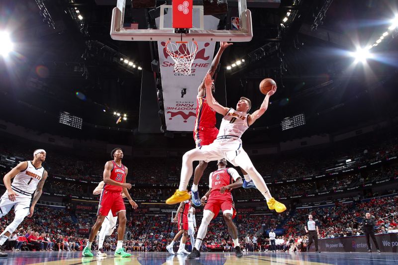 NEW ORLEANS, LA - NOVEMBER 15: Christian Braun #0 of the Denver Nuggets drives to the basket during the game against the New Orleans Pelicans during the Emirates NBA Cup game on November 15, 2024 at the Smoothie King Center in New Orleans, Louisiana. NOTE TO USER: User expressly acknowledges and agrees that, by downloading and or using this Photograph, user is consenting to the terms and conditions of the Getty Images License Agreement. Mandatory Copyright Notice: Copyright 2024 NBAE (Photo by Layne Murdoch Jr./NBAE via Getty Images)