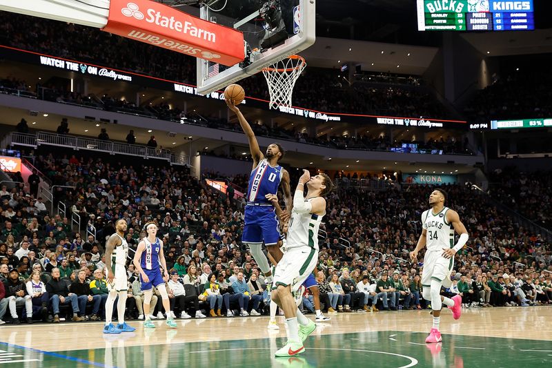 MILWAUKEE, WISCONSIN - JANUARY 14: Malik Monk #0 of the Sacramento Kings scores drives to the basket during the second half of the game against the Milwaukee Bucks at Fiserv Forum on January 14, 2024 in Milwaukee, Wisconsin. NOTE TO USER: User expressly acknowledges and agrees that, by downloading and or using this photograph, User is consenting to the terms and conditions of the Getty Images License Agreement. (Photo by John Fisher/Getty Images)