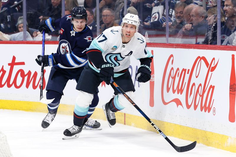 Mar 5, 2024; Winnipeg, Manitoba, CAN; Winnipeg Jets center Vladislav Namestnikov (7) and Seattle Kraken center Jaden Schwartz (17) chase after the puck in the first period at Canada Life Centre. Mandatory Credit: James Carey Lauder-USA TODAY Sports