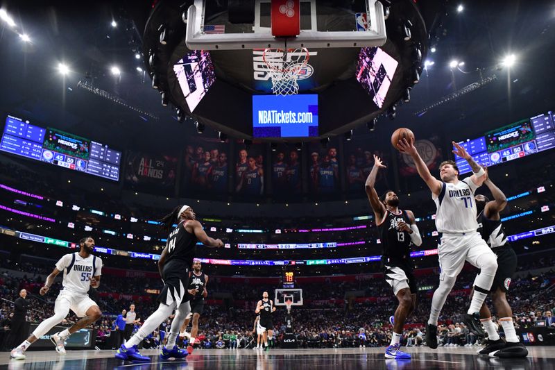 LOS ANGELES, CA - APRIL 23: Luka Doncic #77 of the Dallas Mavericks goes to the basket during the game against the LA Clippers during Round 1 Game 2 of the 2024 NBA Playoffs on April 23, 2024 at Crypto.Com Arena in Los Angeles, California. NOTE TO USER: User expressly acknowledges and agrees that, by downloading and/or using this Photograph, user is consenting to the terms and conditions of the Getty Images License Agreement. Mandatory Copyright Notice: Copyright 2024 NBAE (Photo by Adam Pantozzi/NBAE via Getty Images)