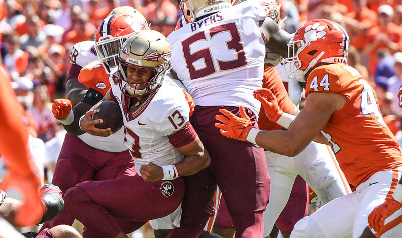 Sep 23, 2023; Clemson, South Carolina, USA; Florida State Seminoles quarterback Jordan Travis (13) runs against Clemson Tigers defensive end Cade Denhoff (44) during the second quarter at Memorial Stadium. Mandatory Credit: Ken Ruinard-USA TODAY Sports