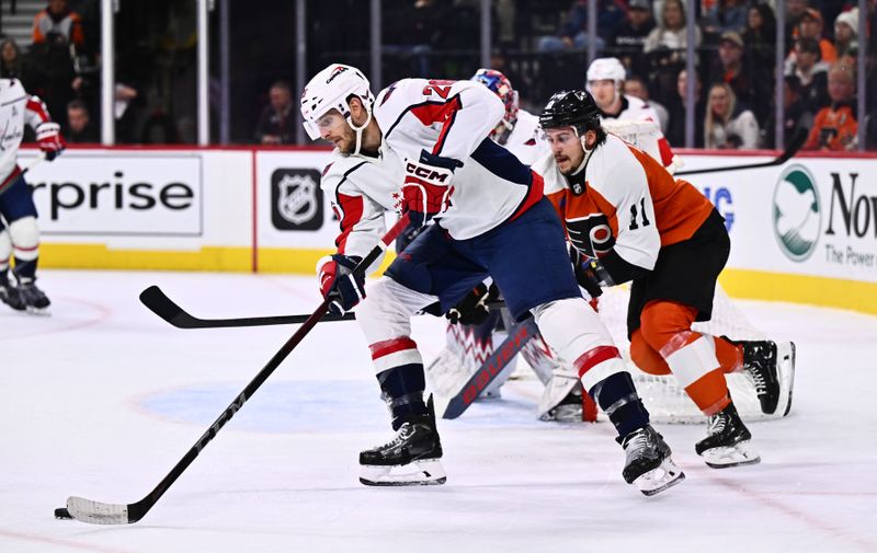 Dec 14, 2023; Philadelphia, Pennsylvania, USA; Washington Capitals right wing Nic Dowd (26) controls the puck against Philadelphia Flyers right wing Travis Konecny (11) in the first period at Wells Fargo Center. Mandatory Credit: Kyle Ross-USA TODAY Sports