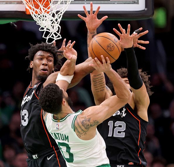 Boston, MA - December 28: Boston Celtics forward Jayson Tatum #0 goes up against Detroit Pistons center James Wiseman #13 and Isaiah Livers #12 during the second half. (Photo by Matt Stone/MediaNews Group/Boston Herald via Getty Images)