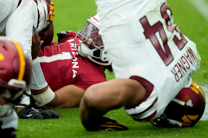 Arizona Cardinals quarterback Kyler Murray (1) is sacked against the Washington Commanders during the first half of an NFL football game, Sunday, Sept. 29, 2024, in Glendale, Ariz. (AP Photo/Ross D. Franklin)