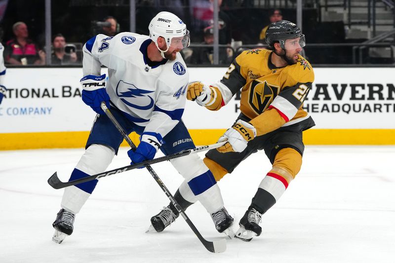 Mar 19, 2024; Las Vegas, Nevada, USA; Vegas Golden Knights right wing Michael Amadio (22) defends against Tampa Bay Lightning defenseman Calvin de Haan (44) during the second period at T-Mobile Arena. Mandatory Credit: Stephen R. Sylvanie-USA TODAY Sports