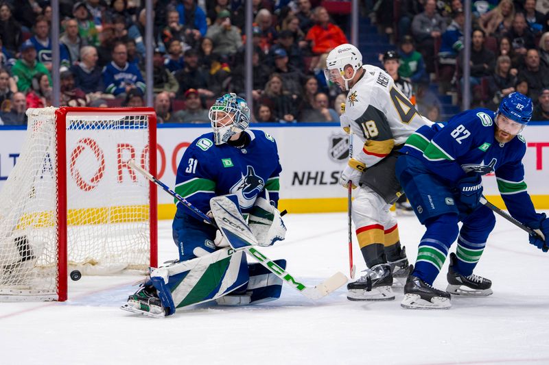 Apr 8, 2024; Vancouver, British Columbia, CAN; Vancouver Canucks defenseman Ian Cole (82) and Vegas Golden Knights forward Tomas Hertl (48) watch as the shot from defenseman Noah Hanifin (15) beats goalie Arturs Silvos (31) in the second period at Rogers Arena. Mandatory Credit: Bob Frid-USA TODAY Sports