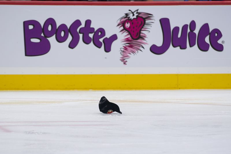 Oct 5, 2024; Ottawa, Ontario, CAN; Hats are thrown to the ice after Ottawa Senators center Shane Pinto (12 - not pictured) scores a hat trick goal in the second period against the Montreal Canadiens  at the Canadian Tire Centre. Mandatory Credit: Marc DesRosiers-Imagn Images