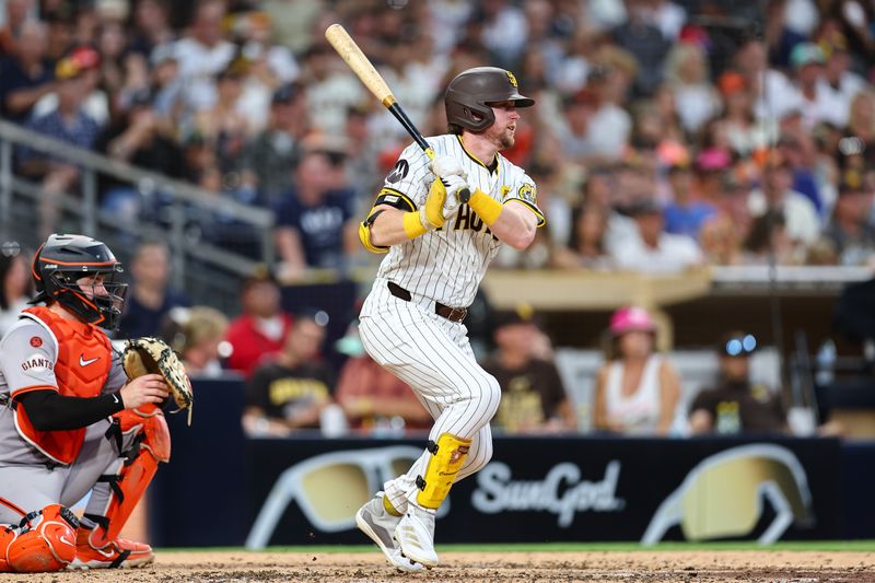 Sep 7, 2024; San Diego, California, USA; San Diego Padres first baseman Jake Cronenworth (9) singles against the San Francisco Giants in the fifth inning at Petco Park. Mandatory Credit: Chadd Cady-Imagn Images