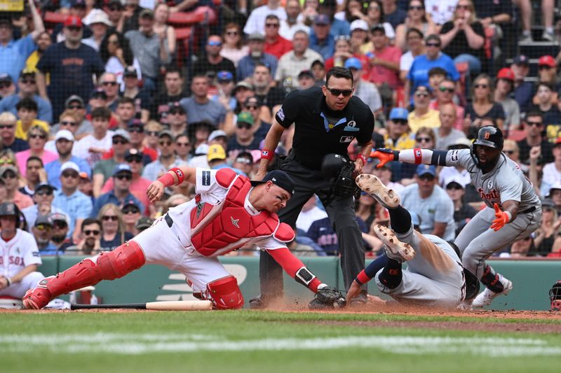 Jun 2, 2024; Boston, Massachusetts, USA;  Detroit Tigers right fielder Wenceel Perez (46) slides safe into home plate coved by Boston Red Sox catcher Reese McGuire (3) during the sixth inning at Fenway Park. Mandatory Credit: Eric Canha-USA TODAY Sports