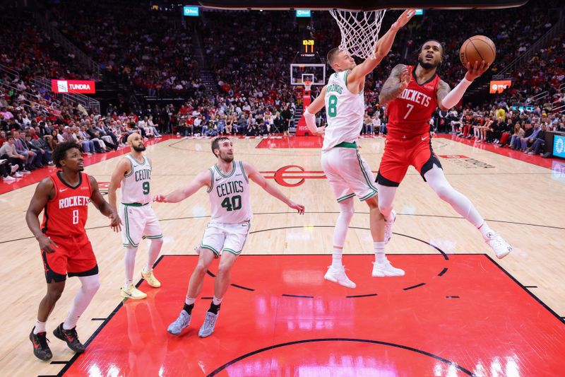 HOUSTON, TEXAS - JANUARY 03: Cam Whitmore #7 of the Houston Rockets shoots against Kristaps Porzingis #8 of the Boston Celtics during the second half at Toyota Center on January 03, 2025 in Houston, Texas. NOTE TO USER: User expressly acknowledges and agrees that, by downloading and or using this photograph, User is consenting to the terms and conditions of the Getty Images License Agreement. (Photo by Alex Slitz/Getty Images)