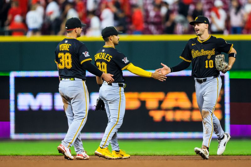 Sep 24, 2025; Cincinnati, Ohio, USA; Pittsburgh Pirates outfielder Bryan Reynolds (10) high fives shortstop Nick Gonzales (39) and second baseman Nick Yorke (38) after the victory over the Cincinnati Reds at Great American Ball Park. Mandatory Credit: Katie Stratman-Imagn Images