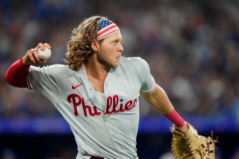 Aug 15, 2023; Toronto, Ontario, CAN; Philadelphia Phillies first baseman Alec Bohm (28) throws the ball back to the pitcher after catching a fly ball hit by Toronto Blue Jays center fielder Daulton Varsho (not pictured) during the fifth inning at Rogers Centre. Mandatory Credit: John E. Sokolowski-USA TODAY Sports