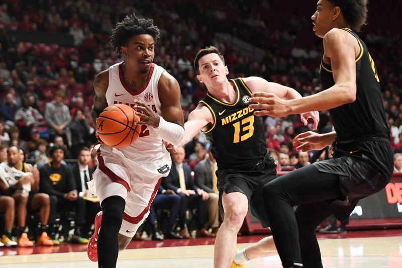 Jan 16, 2024; Tuscaloosa, Alabama, USA; Alabama guard Latrell Wrightsell Jr. (12) drives against Missouri forward Jesus Carralero Martin (13) and Missouri forward Trent Pierce (11) in the game at Coleman Coliseum. Mandatory Credit: Gary Cosby Jr.-USA TODAY Sports