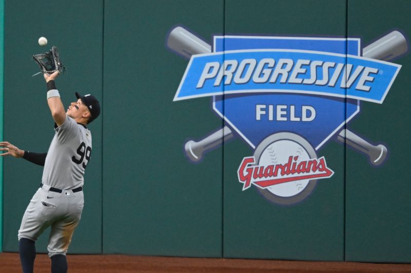 Apr 22, 2025; Cleveland, Ohio, USA; New York Yankees right fielder Aaron Judge (99) makes a catch in the sixth inning against the Cleveland Guardians at Progressive Field. Mandatory Credit: David Richard-Imagn Images