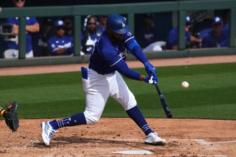 Feb 25, 2024; Phoenix, Arizona, USA; Los Angeles Dodgers designated hitter Manuel Margot (25) bats against the Oakland Athletics during the third inning at Camelback Ranch-Glendale. Mandatory Credit: Joe Camporeale-USA TODAY Sports