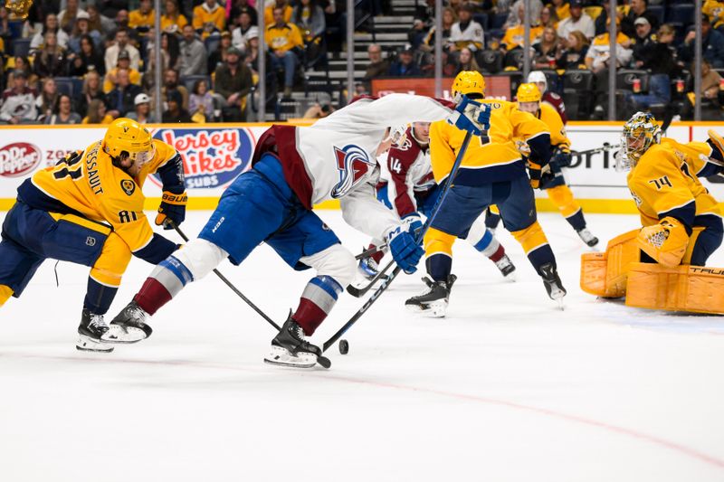 Nov 2, 2024; Nashville, Tennessee, USA;  Nashville Predators center Jonathan Marchessault (81) disrupts the shot of Colorado Avalanche center Nathan MacKinnon (29) during the second period at Bridgestone Arena. Mandatory Credit: Steve Roberts-Imagn Images