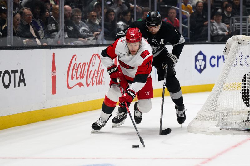Oct 18, 2025; Los Angeles, California, USA; Carolina Hurricanes left wing Taylor Hall (71) and Los Angeles Kings defenseman Cody Ceci (5) vie for the puck during the first period at Crypto.com Arena. Mandatory Credit: William Liang-Imagn Images