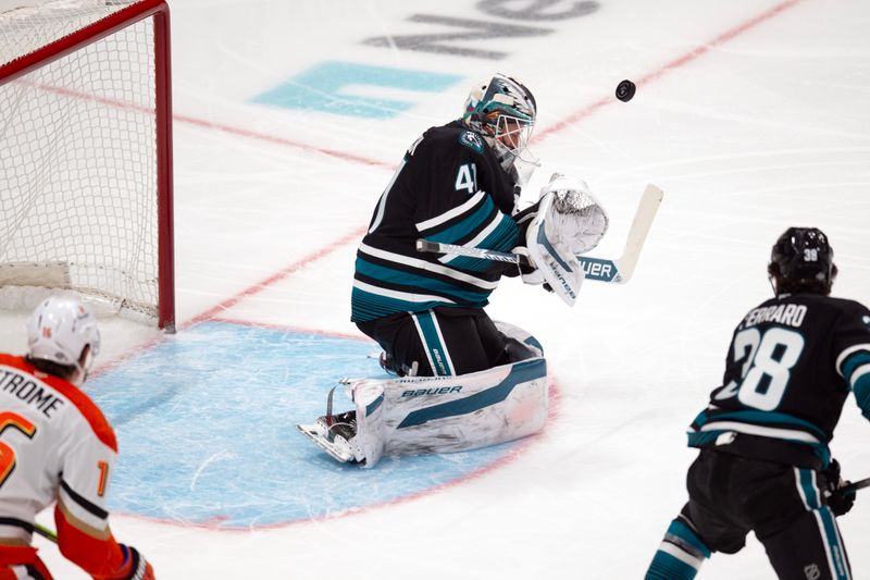 Oct 12, 2024; San Jose, California, USA; San Jose Sharks goaltender Vitek Vanecek (41) deflects a shot on goal by the Anaheim Ducks during the first period at SAP Center at San Jose. Mandatory Credit: D. Ross Cameron-Imagn Images