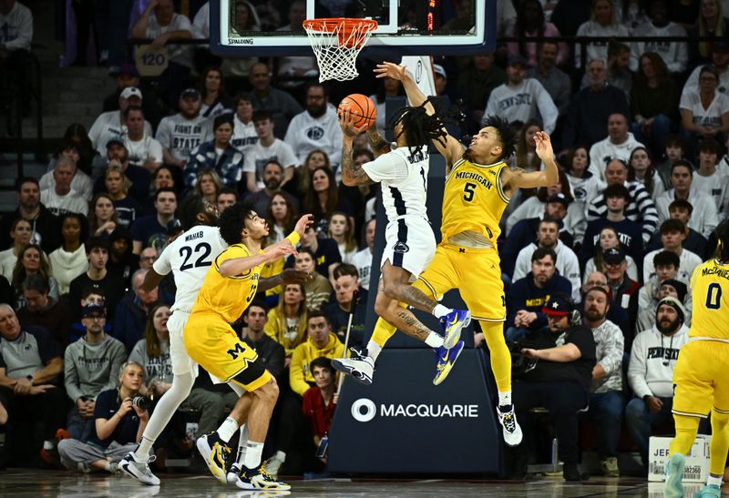 Jan 7, 2024; Philadelphia, Pennsylvania, USA; Penn State Nittany Lions guard Ace Baldwin Jr (1) shoots against Michigan Wolverines forward Terrance Williams II (5) in the second half at The Palestra. Mandatory Credit: Kyle Ross-USA TODAY Sports