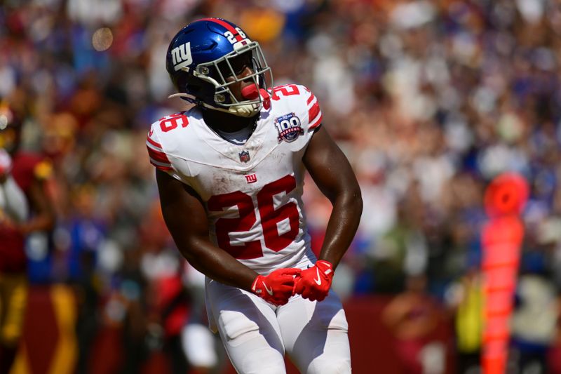 New York Giants running back Devin Singletary (26) celebrates his touchdown run against the Washington Commanders during the first half of an NFL football game in Landover, Md., Sunday, Sept. 15, 2024. (AP Photo/Steve Ruark)