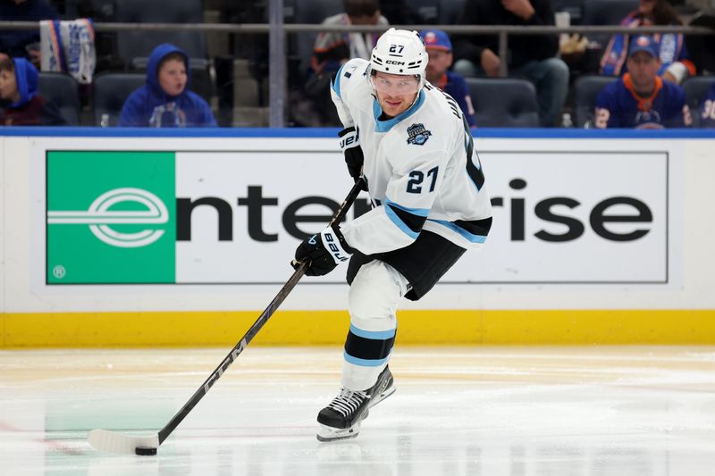 Oct 10, 2024; Elmont, New York, USA; Utah Hockey Club center Barrett Hayton (27) skates with the puck against the New York Islanders during the second period at UBS Arena. Mandatory Credit: Brad Penner-Imagn Images