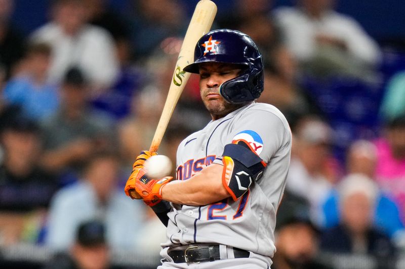 Aug 16, 2023; Miami, Florida, USA; Houston Astros second baseman Jose Altuve (27) moves out of the way of a pitch against the Miami Marlins during the third inning at loanDepot Park. Mandatory Credit: Rich Storry-USA TODAY Sports