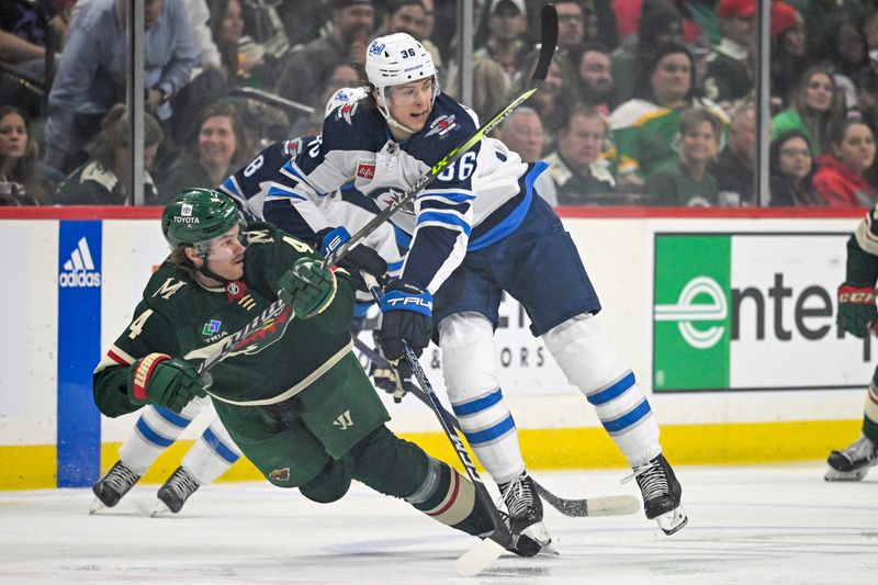 Apr 11, 2023; Saint Paul, Minnesota, USA;  Winnipeg Jets forward Morgan Barron (36) checks Minnesota Wild defense Jon Merrill (4) during the first period at at Xcel Energy Center. Mandatory Credit: Nick Wosika-USA TODAY Sports