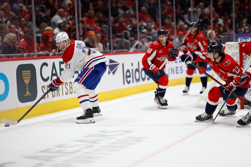 Oct 31, 2024; Washington, District of Columbia, USA; Montreal Canadiens defenseman Kaiden Guhle (21) clears the puck from Washington Capitals center Michael Sgarbossa (23) in the third period at Capital One Arena. Mandatory Credit: Geoff Burke-Imagn Images