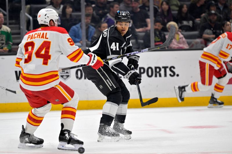 Apr 11, 2024; Los Angeles, California, USA; Los Angeles Kings center Akil Thomas (41) gets the puck past Calgary Flames defenseman Brayden Pachal (94) for a goal in the second period at Crypto.com Arena. Mandatory Credit: Jayne Kamin-Oncea-USA TODAY Sports