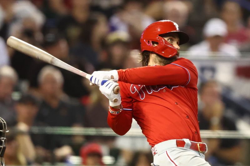 Oct 21, 2023; Phoenix, Arizona, USA; Philadelphia Phillies designated hitter Bryce Harper (3) hits a home run against the Philadelphia Phillies in the sixth inning during game five of the NLCS for the 2023 MLB playoffs at Chase Field. Mandatory Credit: Mark J. Rebilas-USA TODAY Sports