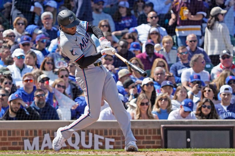 Apr 21, 2024; Chicago, Illinois, USA; Miami Marlins shortstop Tim Anderson (7) hits an RBI single against the Chicago Cubs during the fourth inning at Wrigley Field. Mandatory Credit: David Banks-USA TODAY Sports