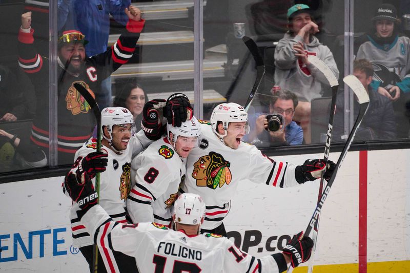 Mar 23, 2024; San Jose, California, USA; Chicago Blackhawks center Philipp Kurashev (23) celebrates with center Ryan Donato (8), center Andreas Athanasiou (89) and left wing Nick Foligno (17) after scoring the game-tying goal against the San Jose Sharks during the third period at SAP Center at San Jose. Mandatory Credit: Robert Edwards-USA TODAY Sports