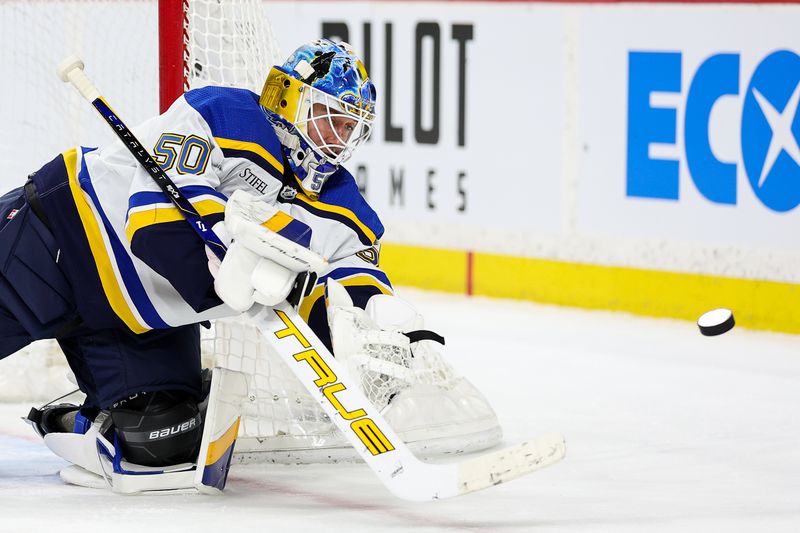 Mar 23, 2024; Saint Paul, Minnesota, USA; St. Louis Blues goaltender Jordan Binnington (50) makes a save against the Minnesota Wild during the third period at Xcel Energy Center. Mandatory Credit: Matt Krohn-USA TODAY Sports