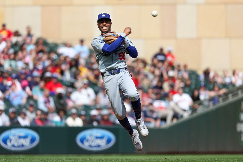 Apr 10, 2024; Minneapolis, Minnesota, USA; Los Angeles Dodgers shortstop Mookie Betts (50) throws the ball to first base to get out Minnesota Twins shortstop Carlos Correa (4) during the seventh inning at Target Field. Mandatory Credit: Matt Krohn-USA TODAY Sports