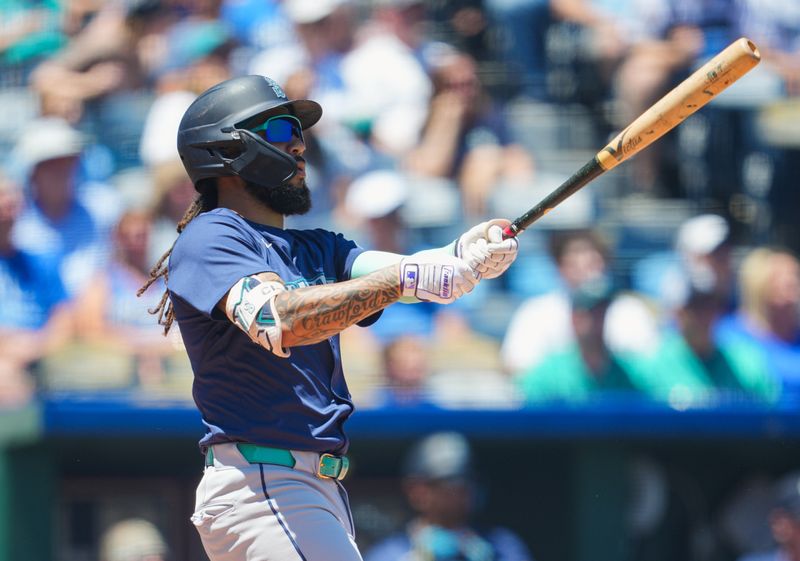 Jun 9, 2024; Kansas City, Missouri, USA; Seattle Mariners shortstop J.P. Crawford (3) hits a home run during the first inning against the Kansas City Royals at Kauffman Stadium. Mandatory Credit: Jay Biggerstaff-USA TODAY Sports