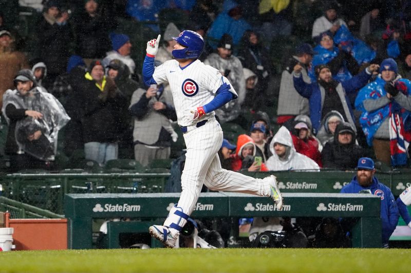 Apr 3, 2024; Chicago, Illinois, USA; Chicago Cubs right fielder Seiya Suzuki (27) hits a home run against the Colorado Rockies during the fifth inning at Wrigley Field. Mandatory Credit: David Banks-USA TODAY Sports