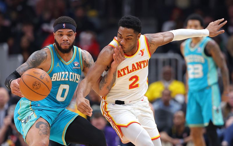 ATLANTA, GEORGIA - MARCH 23:  Trent Forrest #2 of the Atlanta Hawks steals the ball from Miles Bridges #0 of the Charlotte Hornets during the first quarter at State Farm Arena on March 23, 2024 in Atlanta, Georgia.  NOTE TO USER: User expressly acknowledges and agrees that, by downloading and/or using this photograph, user is consenting to the terms and conditions of the Getty Images License Agreement.  (Photo by Kevin C. Cox/Getty Images)