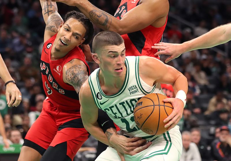 Boston, MA - October 5: Boston Celtics SG Payton Pritchard pulls down a rebound in overtime. The Celtics lost to the Toronto Raptors, 125-119. (Photo by John Tlumacki/The Boston Globe via Getty Images)