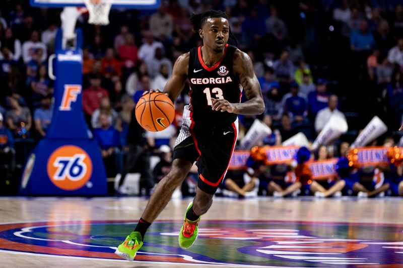 Jan 7, 2023; Gainesville, Florida, USA; Georgia Bulldogs guard Mardrez McBride (13) drives to the basket during the first half against the Florida Gators at Exactech Arena at the Stephen C. O'Connell Center. Mandatory Credit: Matt Pendleton-USA TODAY Sports