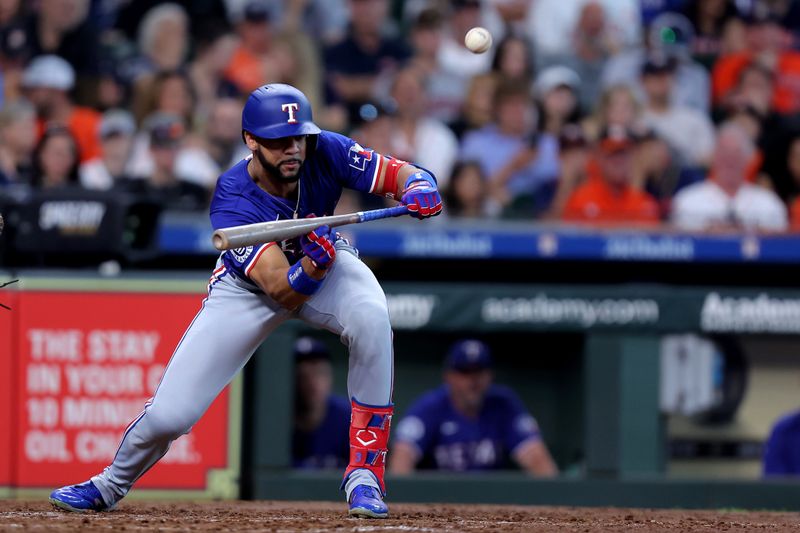 Jul 13, 2024; Houston, Texas, USA; Texas Rangers center fielder Leody Taveras (3) bunts against the Houston Astros during the seventh inning at Minute Maid Park. Mandatory Credit: Erik Williams-USA TODAY Sports