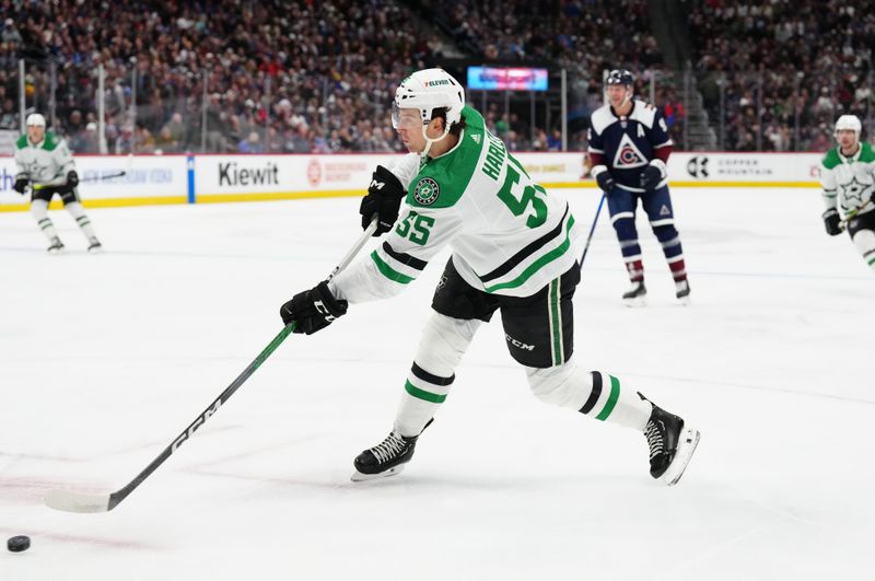 Feb 27, 2024; Denver, Colorado, USA; Dallas Stars defenseman Thomas Harley (55) shoots the puck in the first period goal against the Colorado Avalanche at Ball Arena. Mandatory Credit: Ron Chenoy-USA TODAY Sports